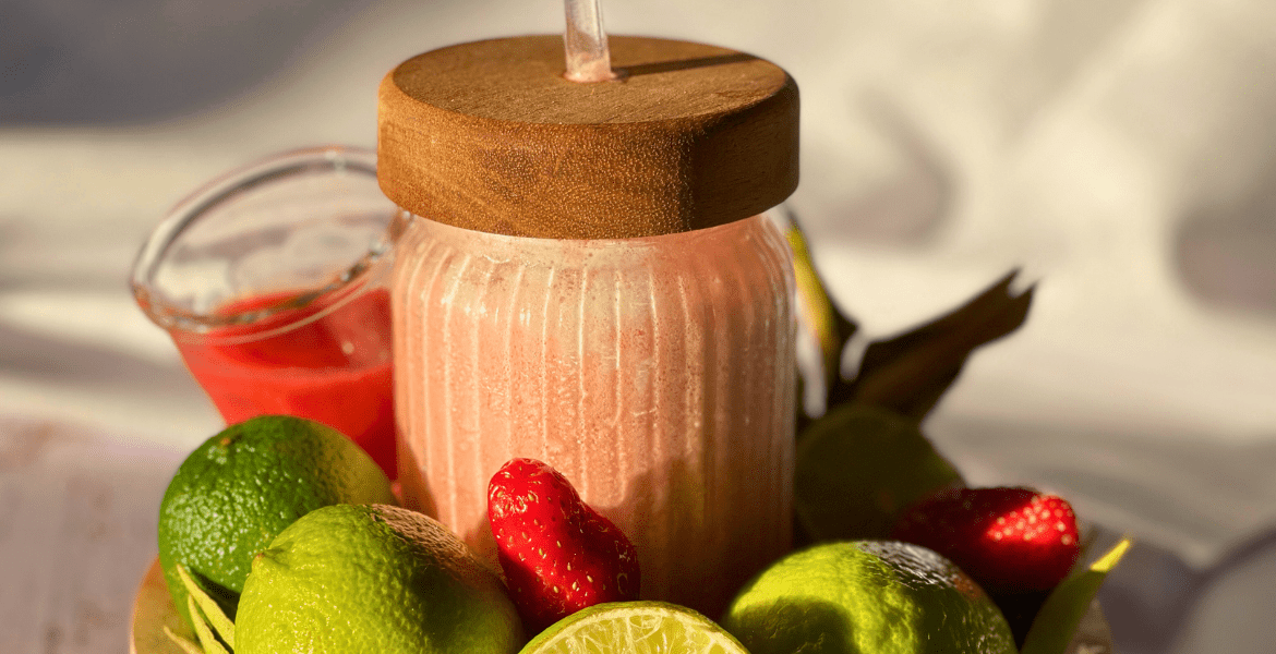 Citronnade sans alcool maison à base de jus de citrons verts, fraises et lait concentré, servie dans un joli bocal – une recette à découvrir sur le blog Deliciously Home.