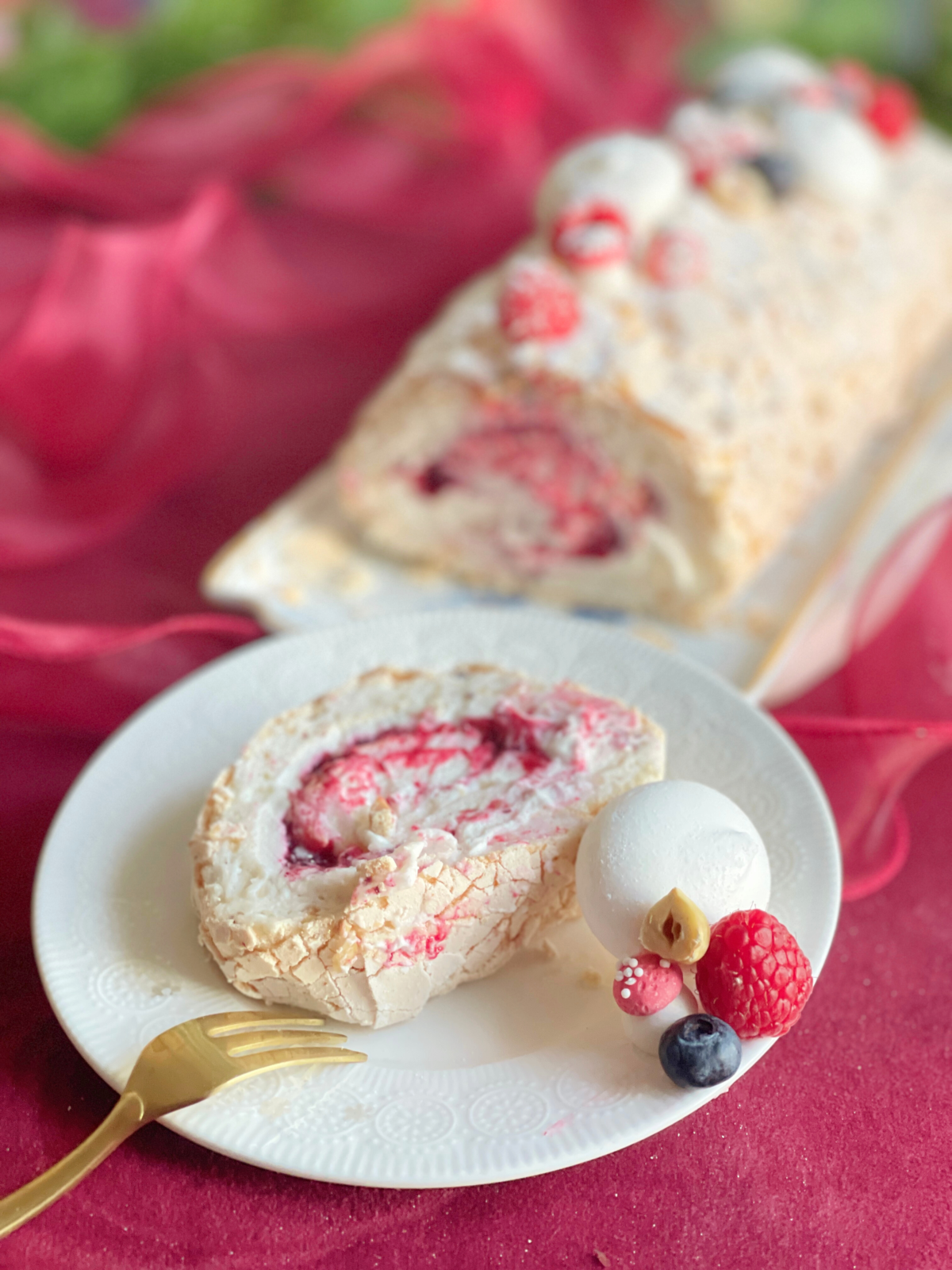 buche noel pavlova deliciouslyhome article3 Part de Bûche Pavlova fruits rouges, noisettes et crème de whisky révélant le contraste entre meringue, chantilly et confit acidulé. Deliciously Home.