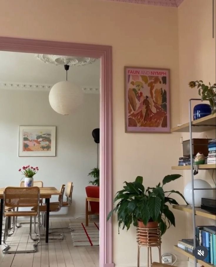 Salon avec porte rose et étagère de plantes