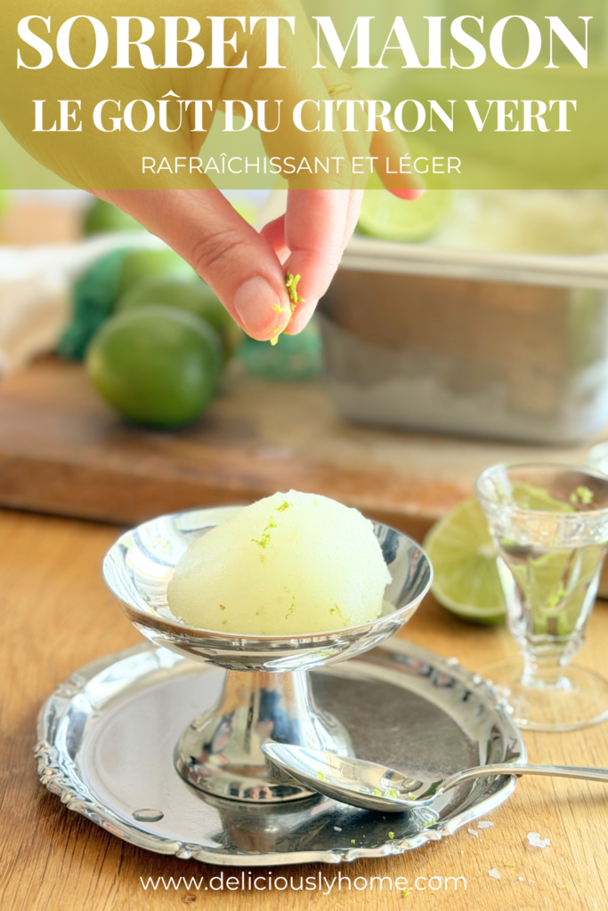 Pin Pinterest d'une recette de sorbet maison au citron vert. Une boule de sorbet est servie dans une coupe en métal tandis que des zestes de citron vert sont ajoutés juste avant la dégustation. Le texte met en avant un dessert rafraîchissant et léger. Découvrez la recette complète sur Deliciously Home.